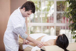 male massage therapist massaging