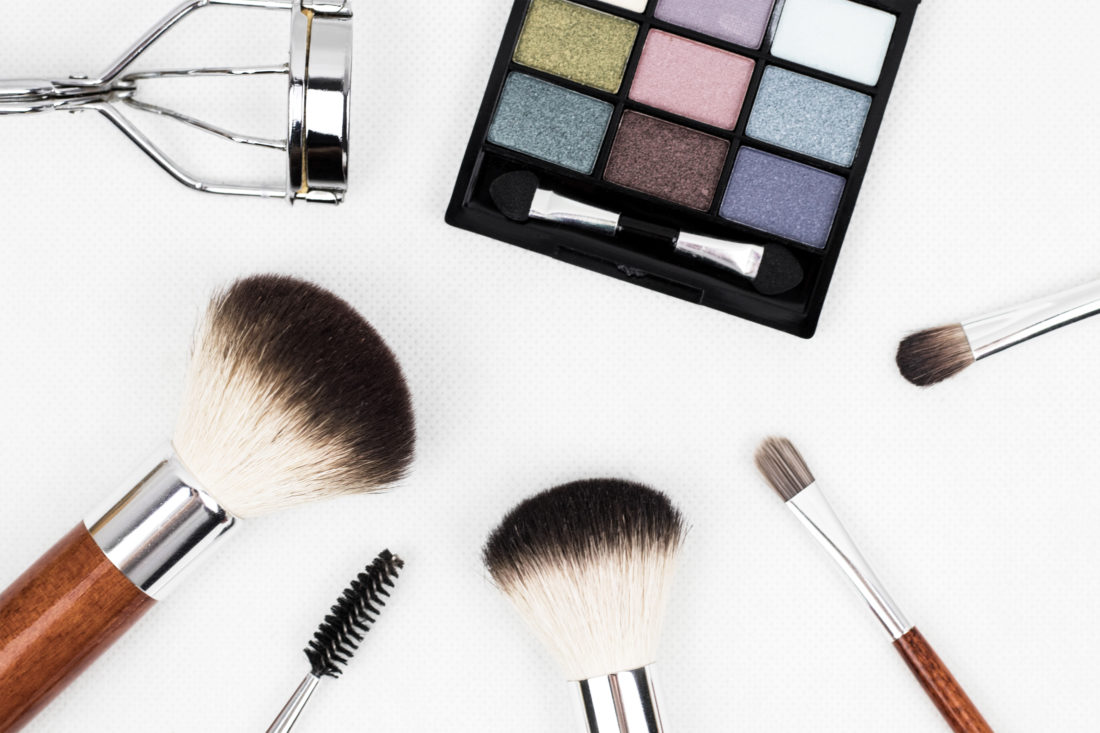 makeup brushes, eyelash curler, and palette